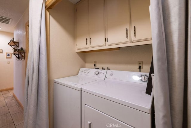 clothes washing area with cabinets and independent washer and dryer