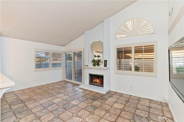 unfurnished living room with a fireplace and high vaulted ceiling