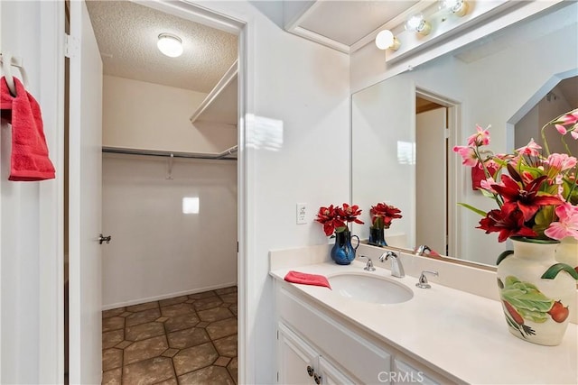 bathroom with a textured ceiling and vanity