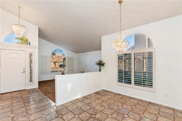 foyer entrance with lofted ceiling and a chandelier