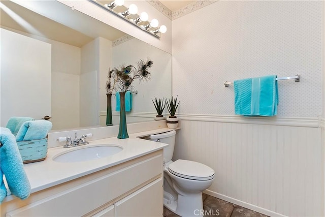 bathroom featuring toilet, tile patterned flooring, and vanity