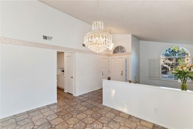 interior space featuring lofted ceiling and a notable chandelier