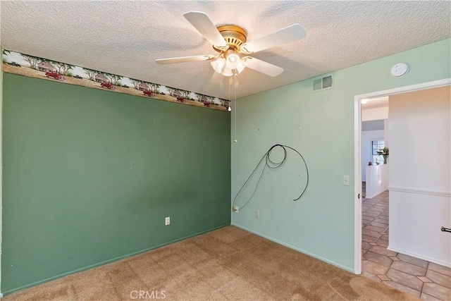 spare room featuring ceiling fan and a textured ceiling