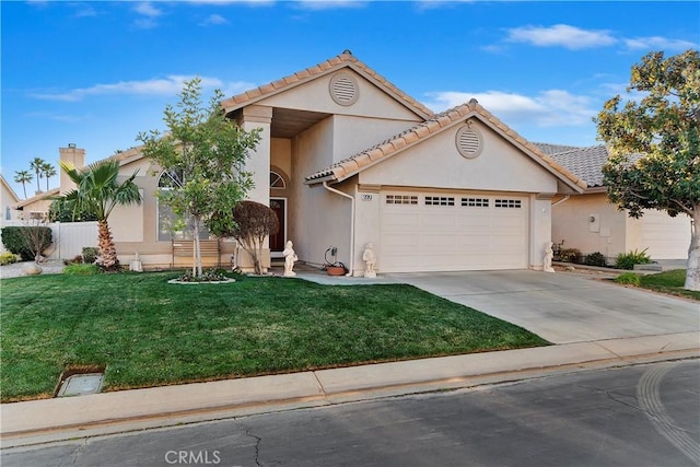 view of front of property with a garage and a front lawn