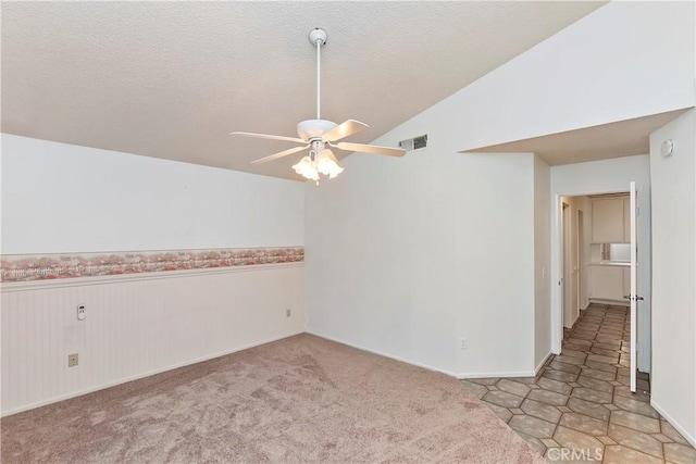 empty room featuring ceiling fan and lofted ceiling