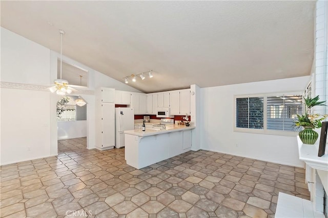 kitchen with white appliances, white cabinets, kitchen peninsula, vaulted ceiling, and ceiling fan