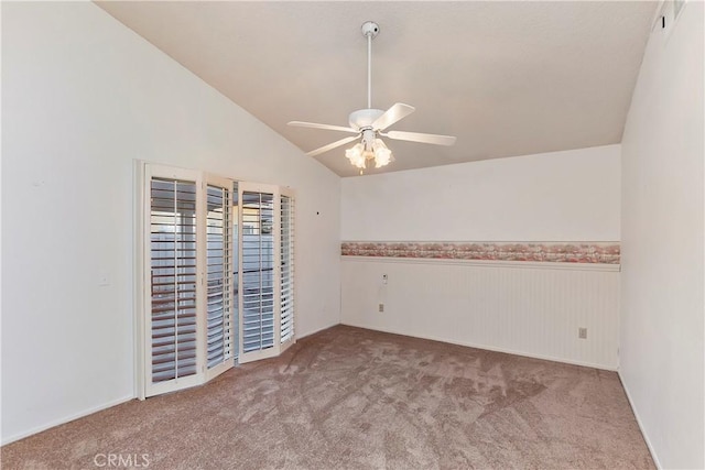 carpeted empty room featuring vaulted ceiling and ceiling fan