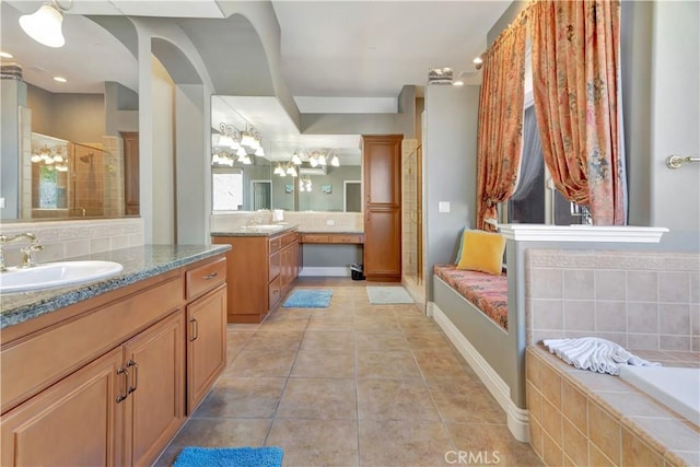 bathroom with tile patterned flooring, vanity, and separate shower and tub