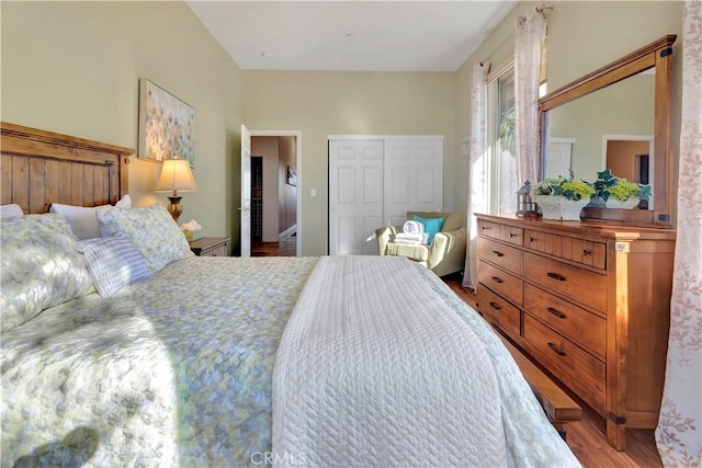 bedroom with light wood-type flooring and a closet