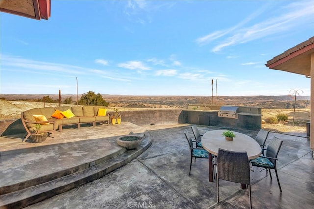 view of patio / terrace featuring grilling area, exterior kitchen, and an outdoor hangout area