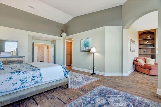 bedroom with hardwood / wood-style flooring and high vaulted ceiling