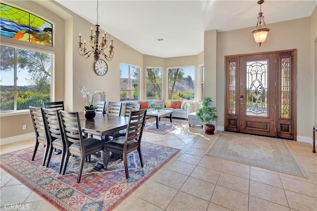 dining area featuring vaulted ceiling, light tile patterned floors, and a chandelier