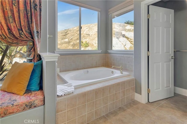 bathroom featuring tile patterned floors and tiled tub