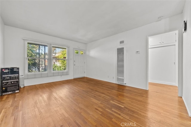 interior space featuring heating unit and light hardwood / wood-style flooring