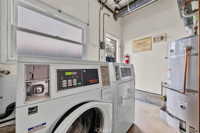 laundry area featuring secured water heater and washing machine and clothes dryer