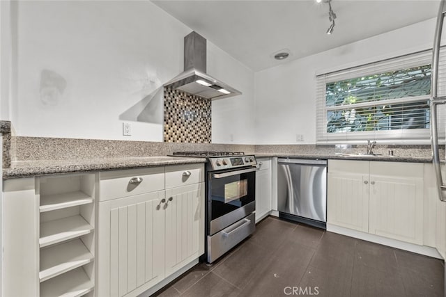 kitchen with white cabinetry, sink, wall chimney exhaust hood, light stone counters, and appliances with stainless steel finishes