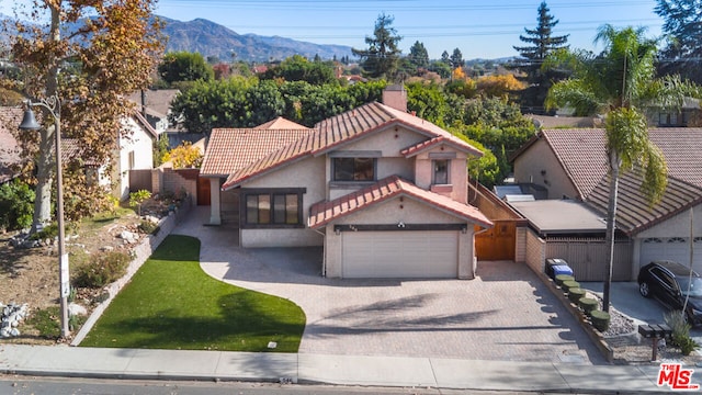 view of front of house with a mountain view and a garage