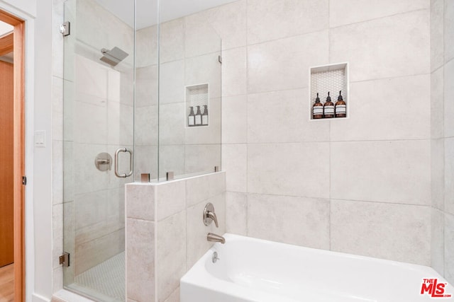 bathroom with shower with separate bathtub