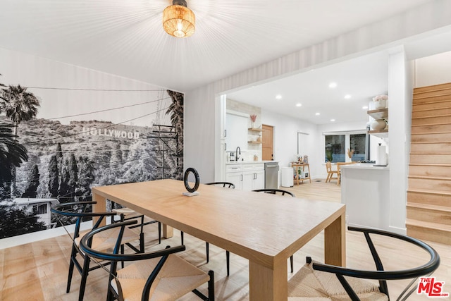 dining room featuring sink and light wood-type flooring