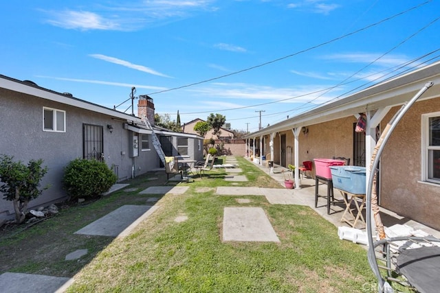 view of yard featuring a patio and fence