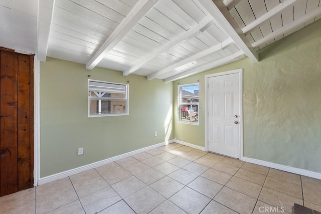 spare room featuring lofted ceiling with beams, baseboards, wood ceiling, and light tile patterned flooring