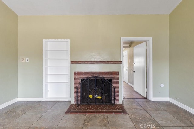 unfurnished living room featuring a fireplace and baseboards