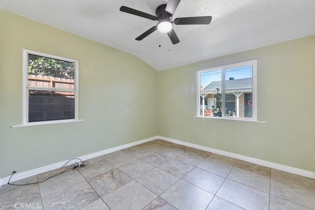 unfurnished room featuring baseboards, ceiling fan, tile patterned flooring, and vaulted ceiling