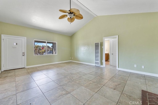 empty room featuring tile patterned floors, baseboards, ceiling fan, and vaulted ceiling