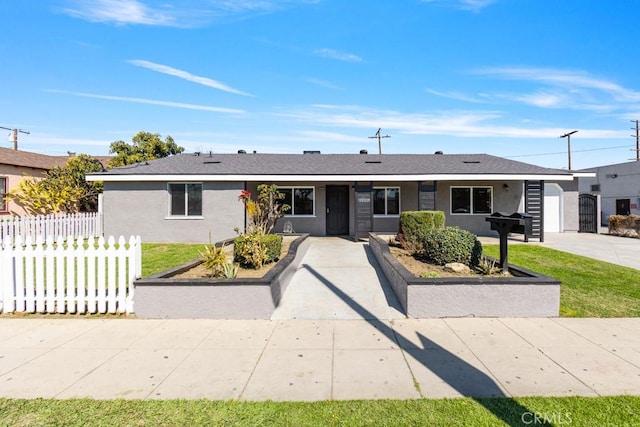 ranch-style home with stucco siding and fence