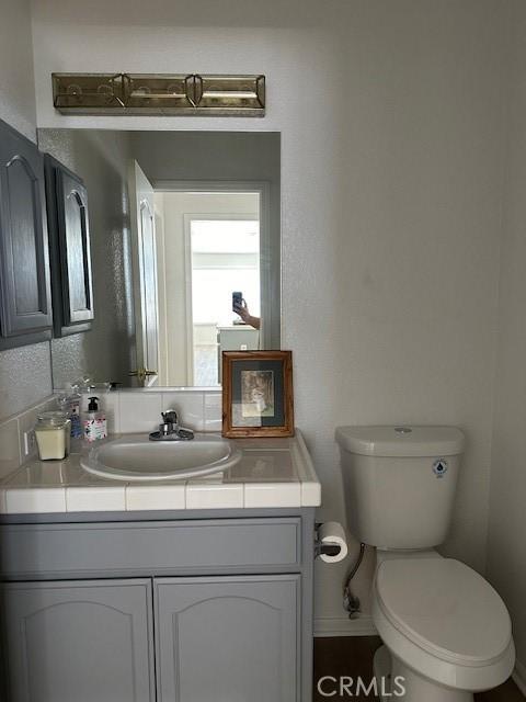 bathroom with vanity and toilet