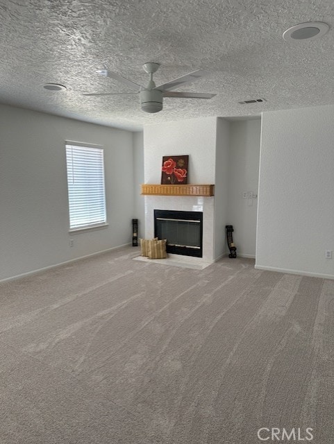 unfurnished living room featuring carpet, a textured ceiling, and ceiling fan