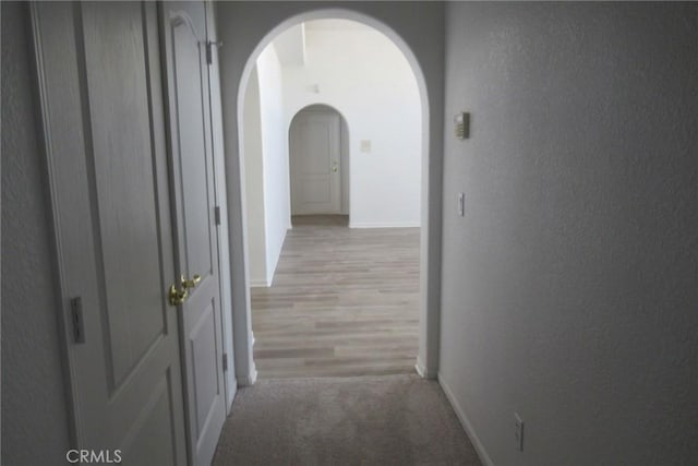 hallway with light hardwood / wood-style floors