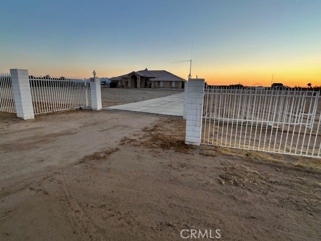 view of gate at dusk