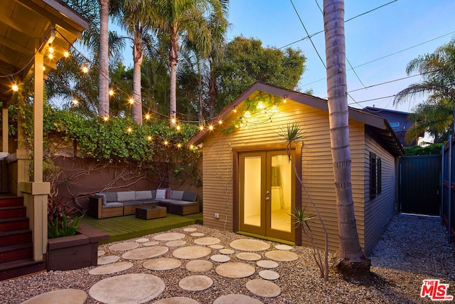 view of outdoor structure with outdoor lounge area and french doors