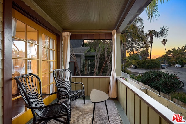 balcony at dusk with a porch