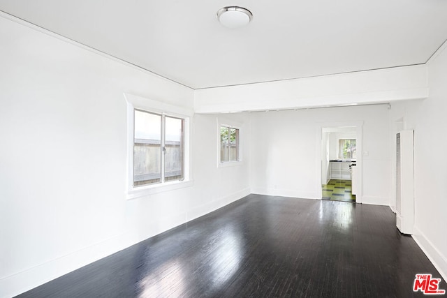 spare room with dark wood-type flooring