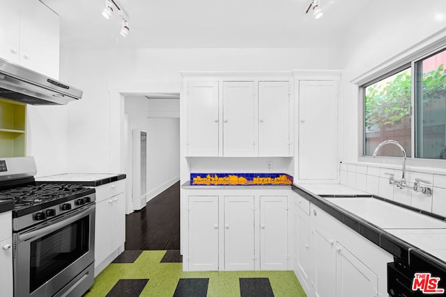 kitchen featuring white cabinetry, sink, tile counters, stainless steel range with gas cooktop, and dark hardwood / wood-style flooring