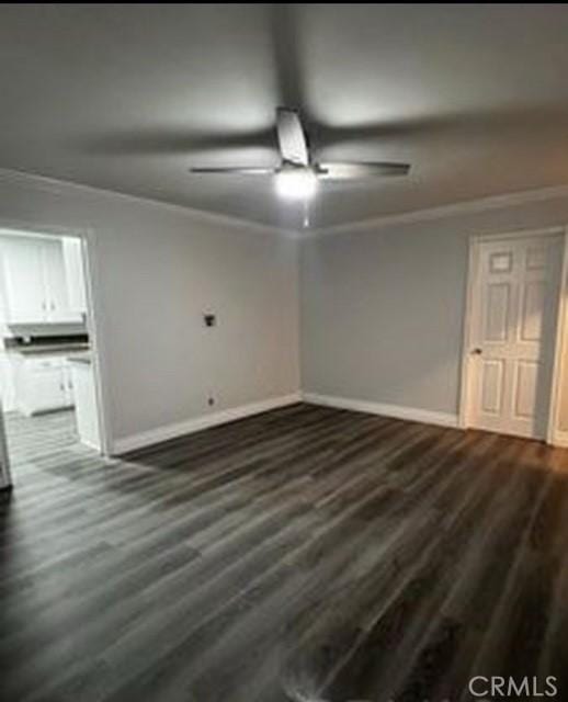 unfurnished room with ornamental molding, dark hardwood / wood-style floors, and ceiling fan