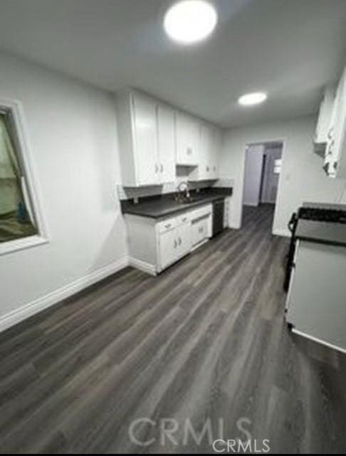 kitchen featuring dark wood-type flooring and white cabinets