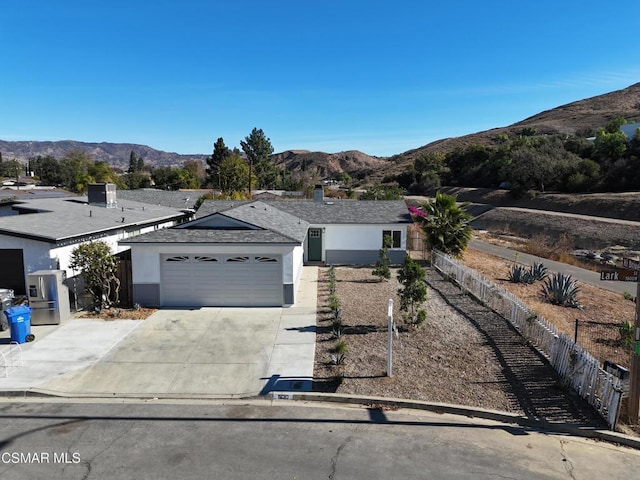 ranch-style home with a mountain view and a garage