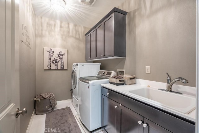 laundry area featuring sink, cabinets, washer and clothes dryer, and light tile patterned flooring