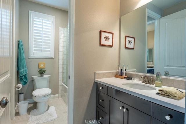 full bathroom featuring toilet, tile patterned flooring, vanity, and washtub / shower combination