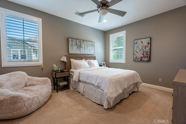 bedroom with ceiling fan and light colored carpet