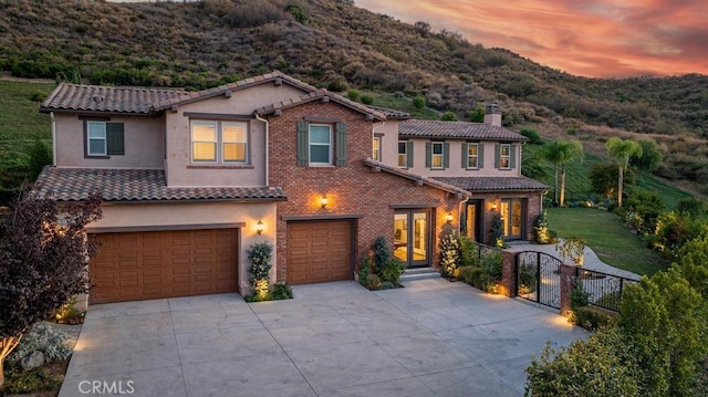 mediterranean / spanish home featuring a garage and a mountain view