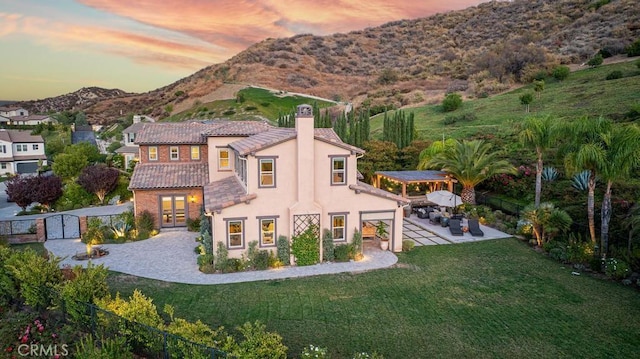 exterior space featuring a patio, a yard, french doors, and a mountain view