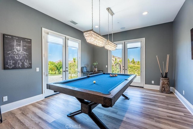 recreation room with french doors, pool table, hardwood / wood-style floors, and a wealth of natural light