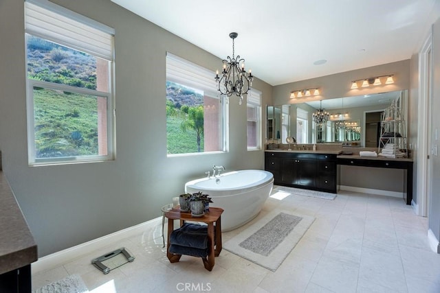 bathroom with vanity, a bathtub, plenty of natural light, and a chandelier