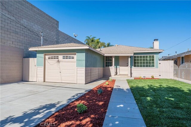 view of front facade with a garage and a front lawn