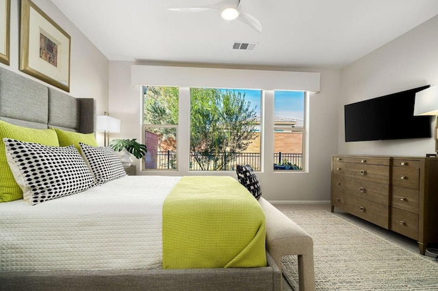 bedroom with multiple windows and ceiling fan