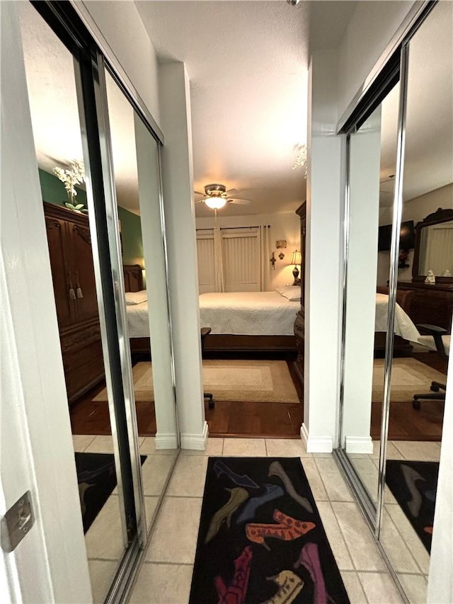 bathroom featuring a ceiling fan, tile patterned floors, and ensuite bathroom